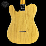 Back view of a Fender electric guitar with a visible brand label on a black background.