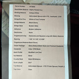 Technical specifications sheet for a guitar on a textured surface