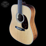 Acoustic guitar with a visible brand logo on a black background