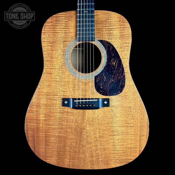 Acoustic guitar with a visible brand logo in the corner
