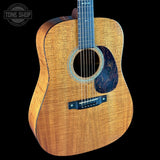 Acoustic guitar with a visible brand logo on a black background