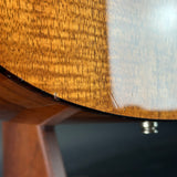 Close-up of a wooden guitar body with a dark finish