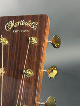 Close-up of a guitar headstock with 'Martin' branding on a gray background