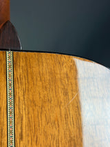 Close-up of a wooden instrument with a dark gray background