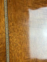 Close-up of a wooden surface with a clear plastic overlay