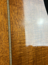 Close-up of a wooden surface with a metal chain and a white textured area.