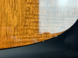 Close-up of a wooden surface with a reflective metal edge.