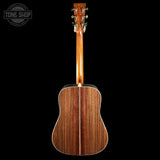 Wooden acoustic guitar on a black background with 'Tone Shop' logo.