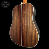 Close-up of a wooden acoustic guitar body with 'Tone Shop' logo.