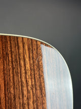 Close-up of a wooden surface with a metallic edge on a gray background