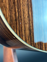 Close-up of a wooden guitar neck with a blurred background