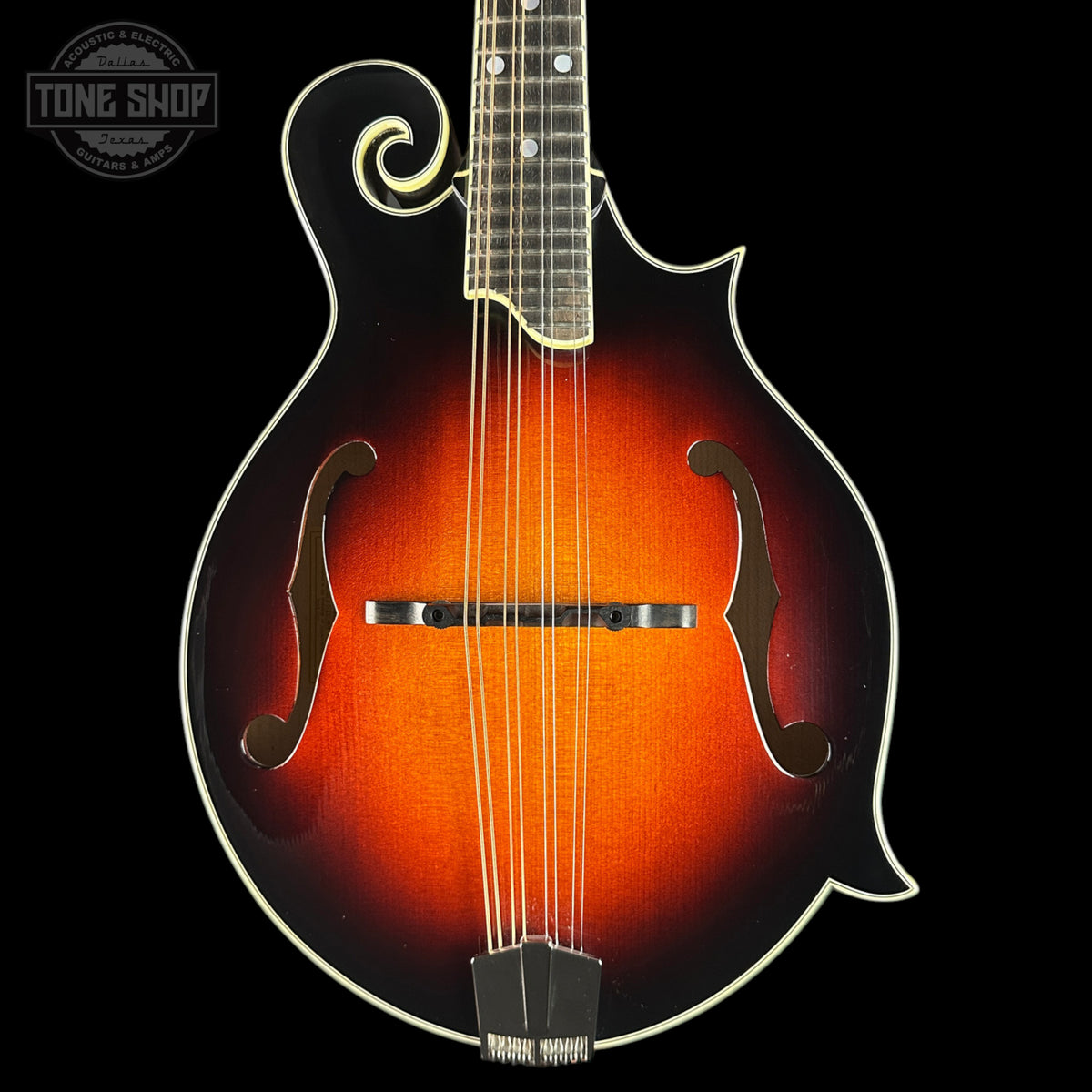 Mandolin with a dark brown finish on a black background, featuring the Tone Shop logo.