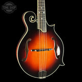 Mandolin with a dark brown finish on a black background, featuring the Tone Shop logo.