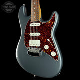 Electric guitar with flame maple top on a black background, featuring the Tone Shop logo.