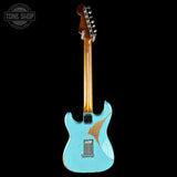 A light blue electric guitar with a distressed finish and a natural wood neck, shown from the headstock side against a black background. A Tone Shop watermark is visible in the top-left corner.