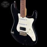 Black electric guitar with a white pickguard on a black background, featuring 'Tone Shop' branding.