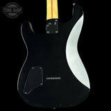 Black electric guitar with a wavy design on the back, brand 'Tone Shop' visible.