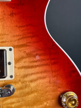 Close-up of a red electric guitar with a sunburst finish