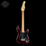 A Fender electric guitar with a glossy dark red body, black pickguard, maple neck, and cream headstock, shown against a solid black background with a Tone Shop watermark in the top-left corner.