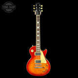 Electric guitar with a sunburst finish on a black background, featuring the Tone Shop logo.