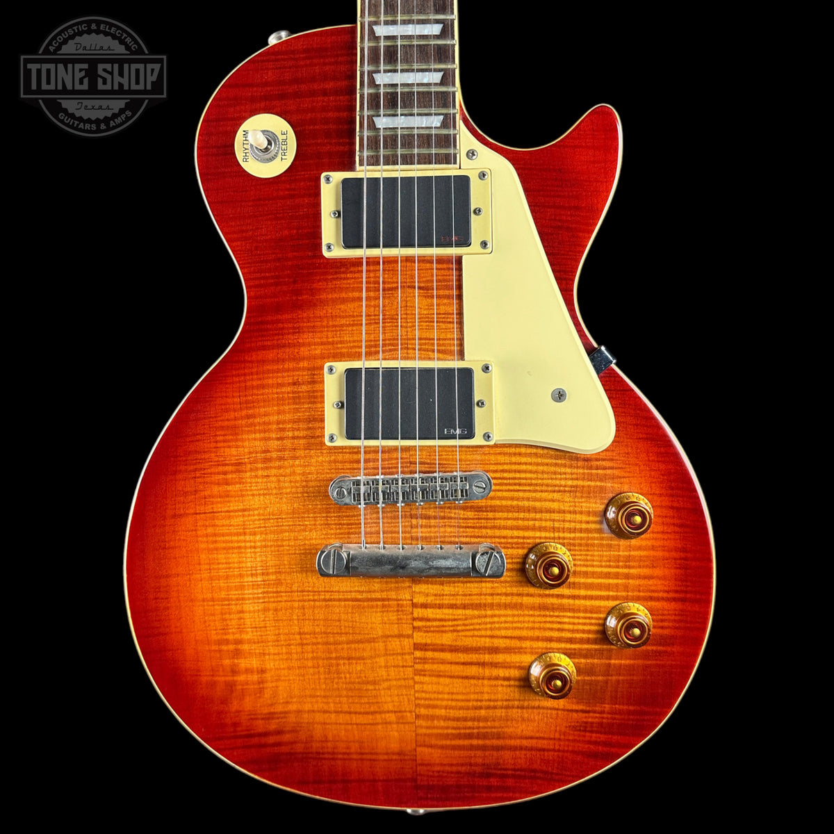 Electric guitar with a sunburst finish on a black background, featuring the Tone Shop logo.