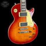 Electric guitar with a sunburst finish on a black background, featuring the Tone Shop logo.