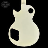 White electric guitar on a black background