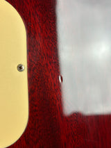 Close-up of a guitar's neck and headstock with a white label.