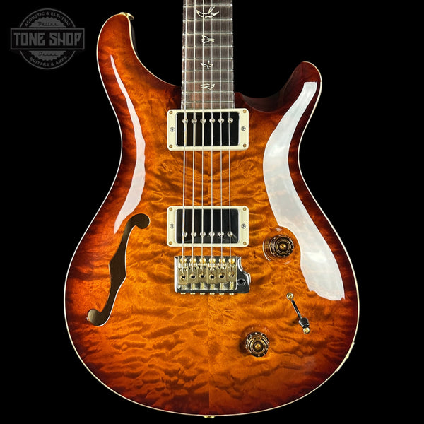 Electric guitar with a quilted top and brand logo in the corner