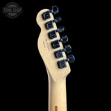Close-up of the headstock of a Fender Stratocaster electric guitar in a natural maple finish, featuring six black tuning pegs and a Tone Shop watermark in the upper left corner, set against a solid black background.