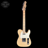 A natural wood Fender Telecaster electric guitar with a white pickguard and black hardware, shown vertically against a solid black background. A Tone Shop watermark is visible in the top-left corner.
