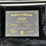 Certificate of Authenticity for a musical instrument on a textured surface