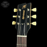 Guitar headstock with 'Revenge' branding on a black background
