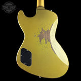 Gold electric guitar with a worn finish on a black background, featuring 'Tone Shop' logo.