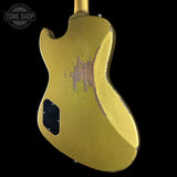 Vintage gold electric guitar with a visible brand logo in the corner.