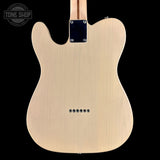 The back of a natural wood electric guitar, showing the body, pickups, and part of the neck against a solid black background.