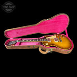 Gibson Les Paul guitar in a pink case with 'Tone Shop' logo.