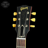 Gibson Les Paul guitar headstock with tuning pegs on a black background