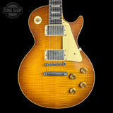 Electric guitar with a sunburst finish on a black background, featuring the Tone Shop logo.