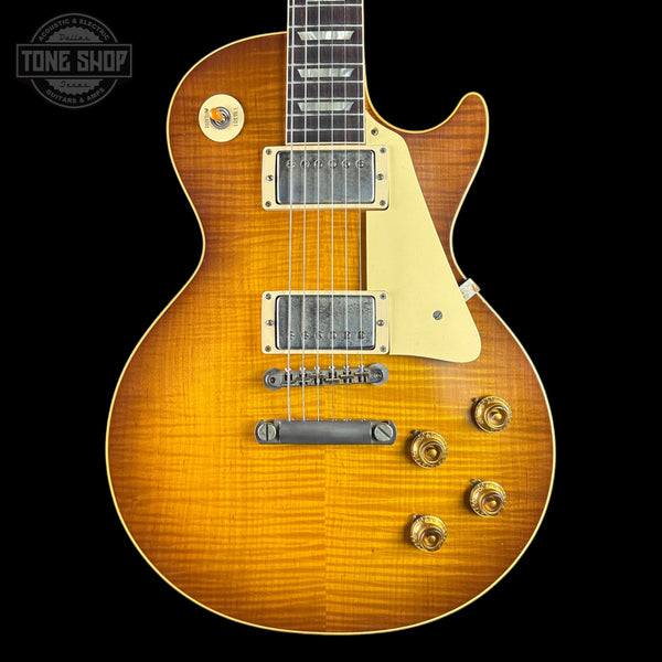 Electric guitar with a sunburst finish on a black background, featuring the Tone Shop logo.