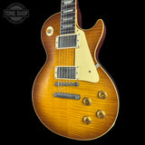 Electric guitar with a sunburst finish on a black background, featuring the Tone Shop logo.