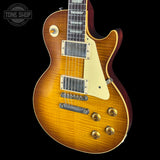 Electric guitar with a sunburst finish on a black background, featuring the Tone Shop logo.