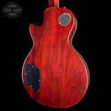 Red electric guitar with a visible brand logo on a black background
