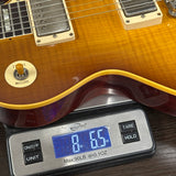 Guitar on a digital scale displaying weight