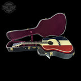 Acoustic guitar with a U.S. flag design inside an open guitar case, branded 'Tone Shop'.