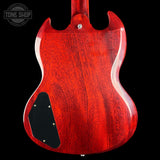 Red electric guitar body with a visible brand logo in the corner.