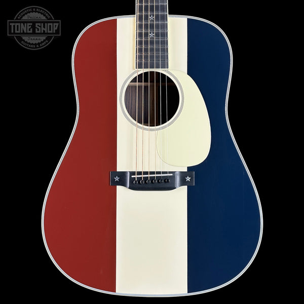 Acoustic guitar with red, white, and blue color pattern on a black background
