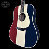 Acoustic guitar with a red, white, and blue striped design on a black background.