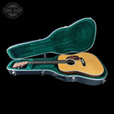 Acoustic guitar in a green case with 'Tone Shop' logo in the corner.