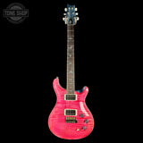 Pink electric guitar with a black background